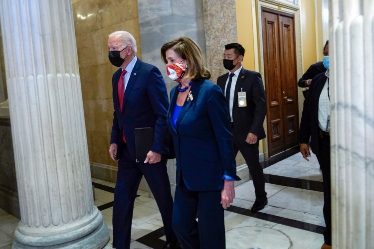 President Joe Biden walks with House Speaker Nancy Pelosi of Calif., on Capitol Hill in Washington, Friday, Oct. 1, 2021, for a meeting with the House Democratic caucus to try to resolve an impasse around the bipartisan infrastructure bill. (AP Photo/Susan Walsh)