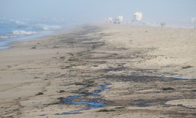 Oil washed up on Huntington Beach, Calif., on Sunday. At least 126,000 gallons of crude spilled into the waters off Orange County.