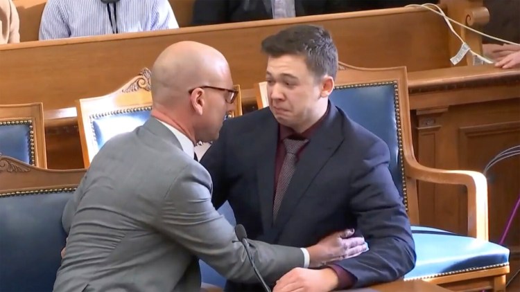 Kyle Rittenhouse is comfort by his lawyer as he was acquitted of all charges at the Kenosha County Courthouse in Kenosha, Wis., on Friday, Nov. 19, 2021.  The jury came back with its verdict after close to 3 1/2 days of deliberation. (AP Photo)