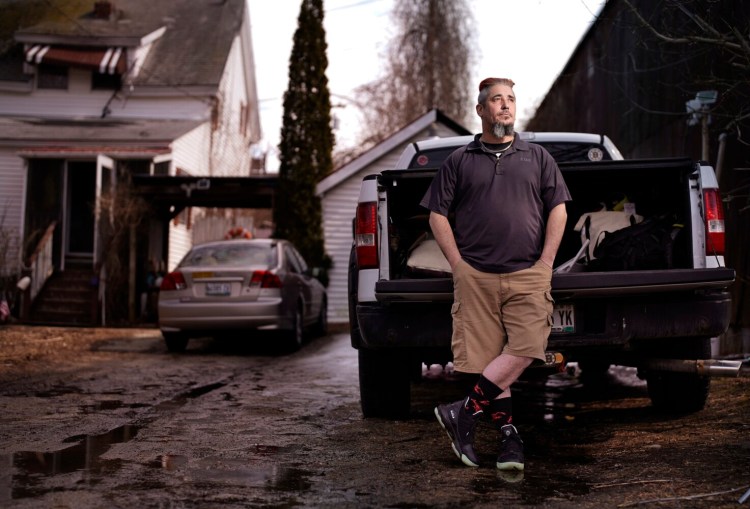 Joseph Parker leans on the bed of his truck at his home in Lewiston on Thursday. Parker, a lobster boat sternman, was asked to return $12,700 in unemployment benefits but said he wasn't notified in time to appeal. He was relieved on Friday when the Maine Department of Labor called him to resolve the issue. 