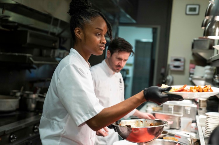 Yadiska van Putten, left, prepares a dish under the direction of chef Charles Gardiner at Gallery Restaurant in Charlotte. Van Putten began working at the restaurant shortly after her graduation from Johnson & Wales. 