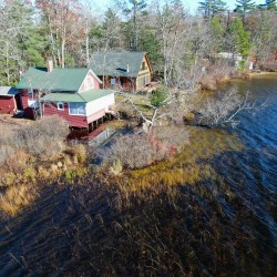 Tripp Pond Aerial photo showing flooding on the Kneeland property on Tripp Pond days before the beaver dam was slowly dismantled in late 2022. Bladders installed by lake association members after the dam was removed raised the water levels back up. Submitted photo