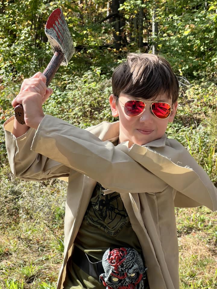 Sullivan Mudie of Augusta was at camp with his mom Lynette Mudie. Sullivan is a Lion Cub in Pack 684 and is in Kindergarten. "I liked seeing the bumblebees," Sullivan said. "And shooting the pumpkins with the BB Gun." The Haunted House beneath the dining hall was guarded by the Grim Reaper (Joseph Maranda) of Augusta and his son Owen Maranda of Augusta and Chelsea. Owen is a Tenderfoot Scout in Troop 631 where his dad is one of the Assistant Scoutmasters. "I'm having fun directing people into the Haunted House," Owen said.